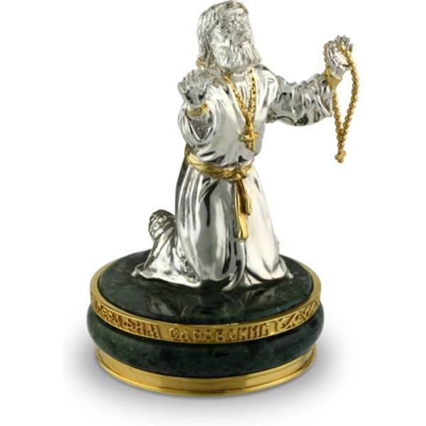 Sculpture on marble of Seraphim of Sarov made of gilded brass